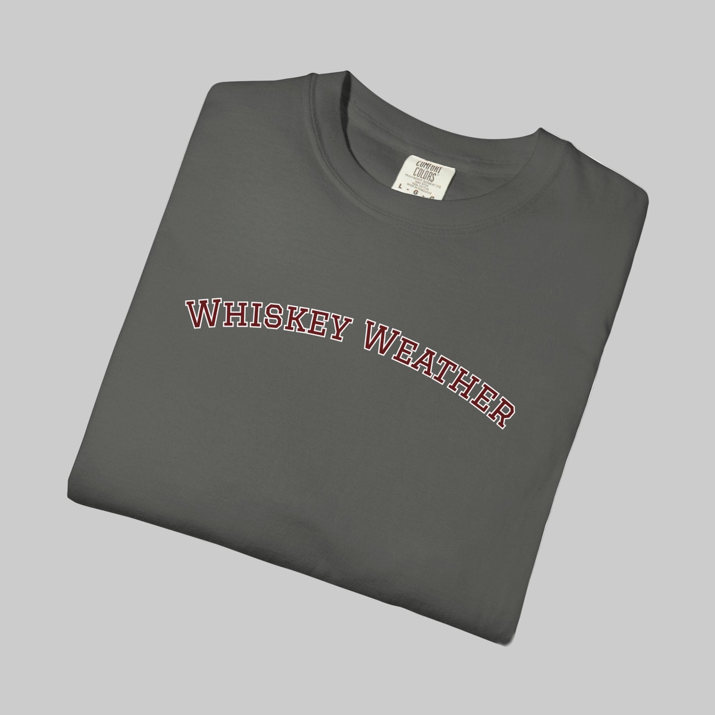 Folded gray t-shirt with 'WHISKEY WEATHER' text on a white background
