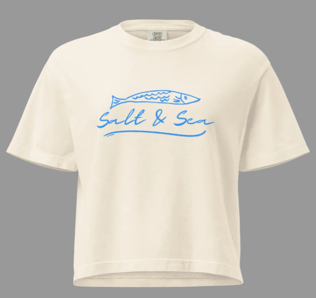 Beige t-shirt with blue graphic and text on a white background