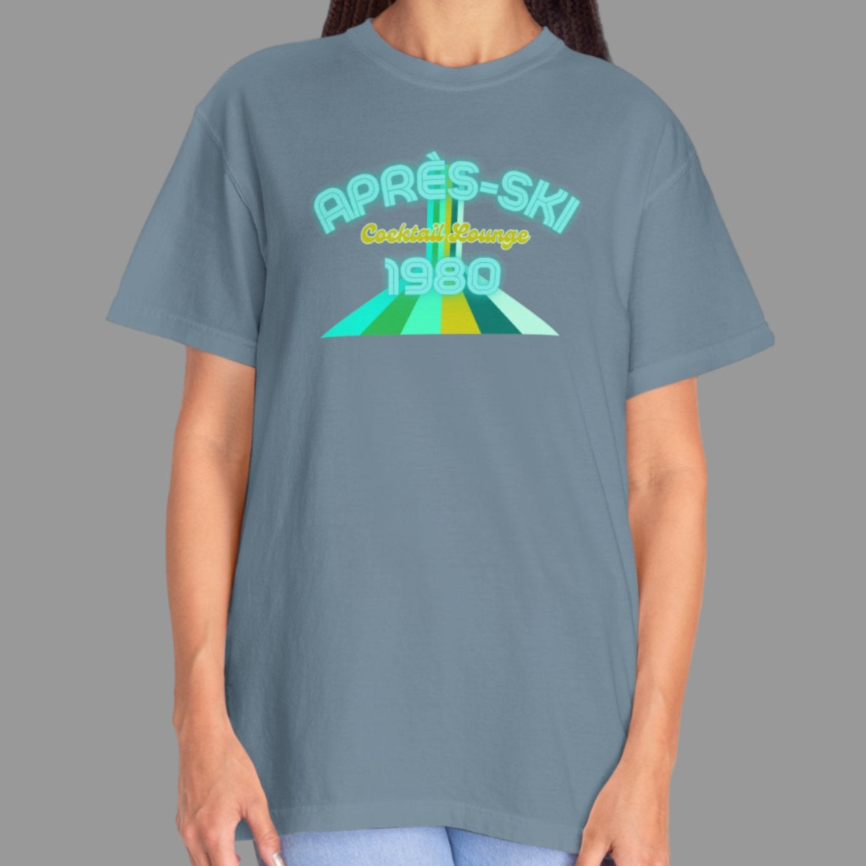 Person wearing a gray t-shirt with a colorful graphic design on a white background