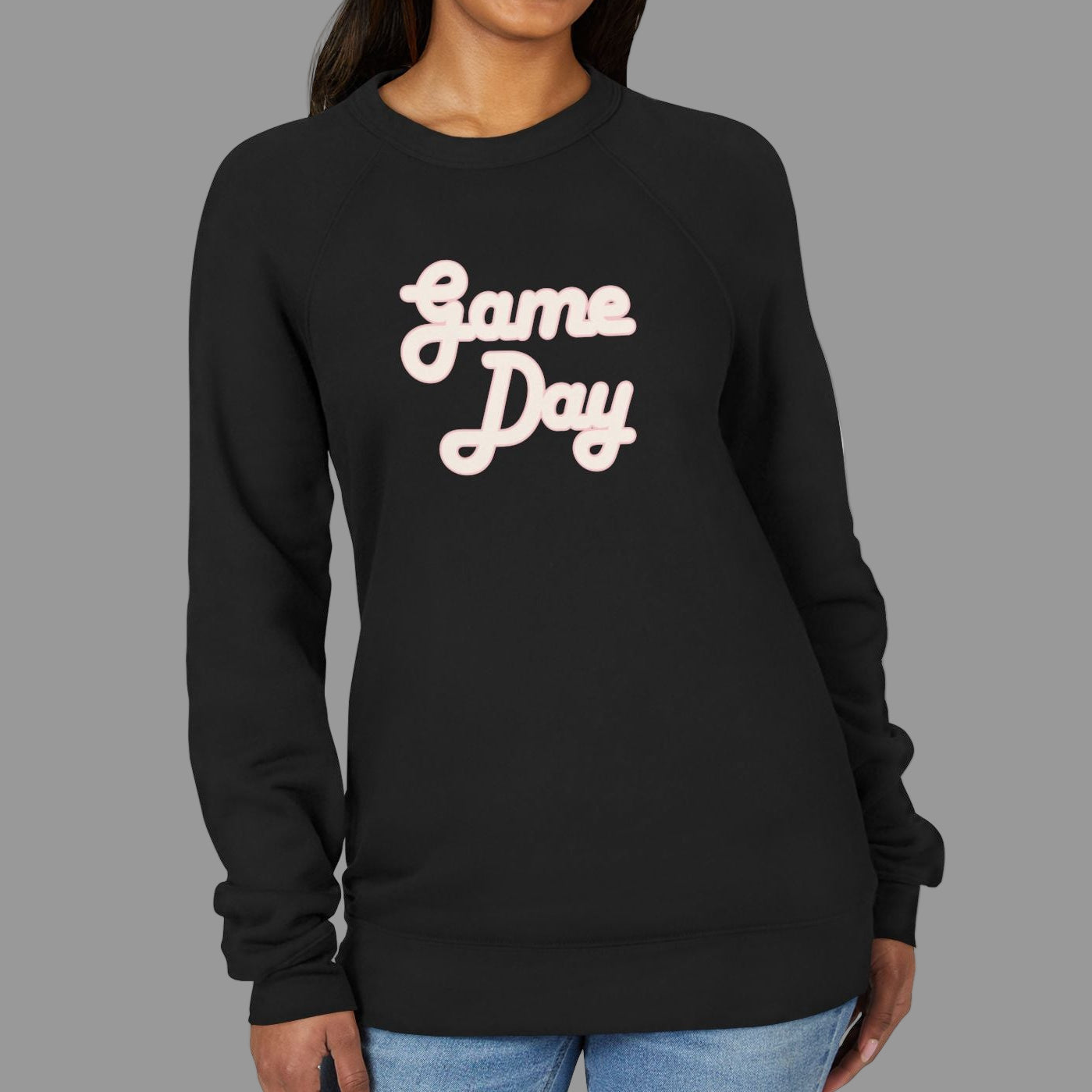Woman wearing a black sweatshirt with 'Game Day' text on a white background
