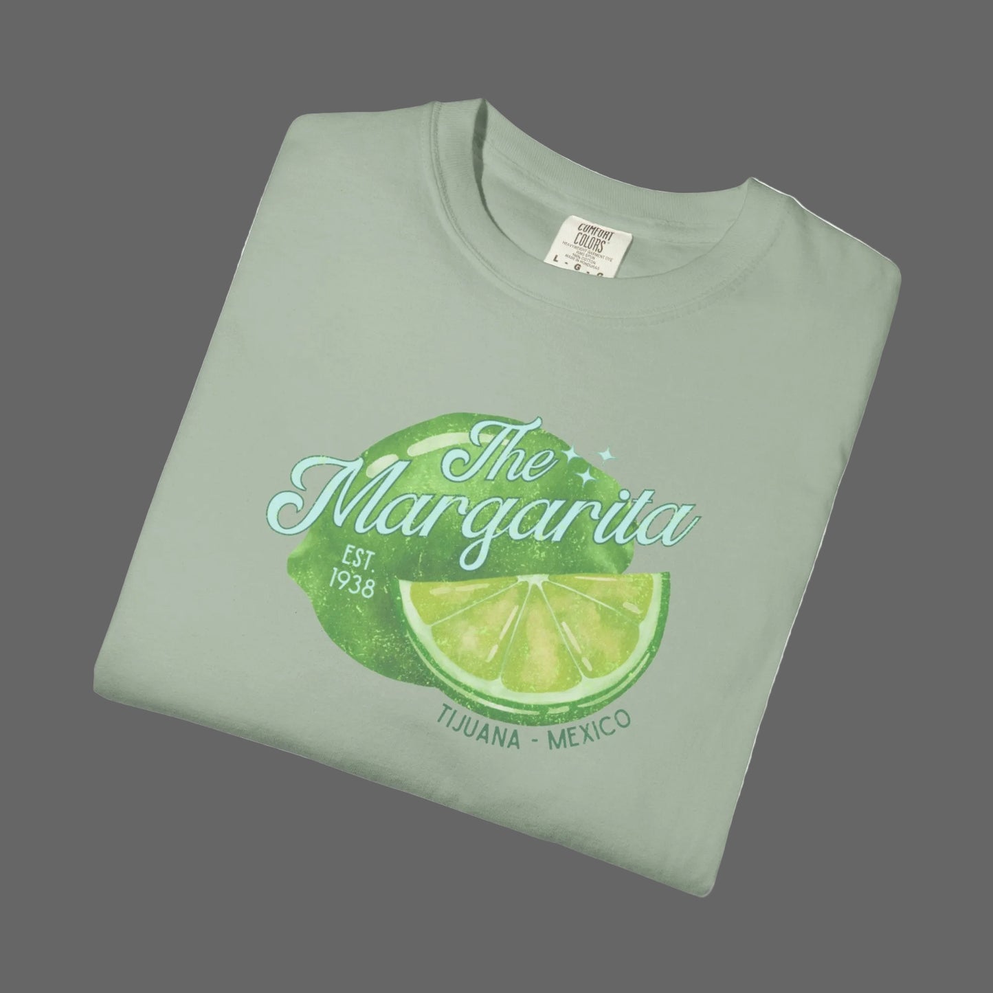 Folded green t-shirt with 'The Margarita' design on a white background