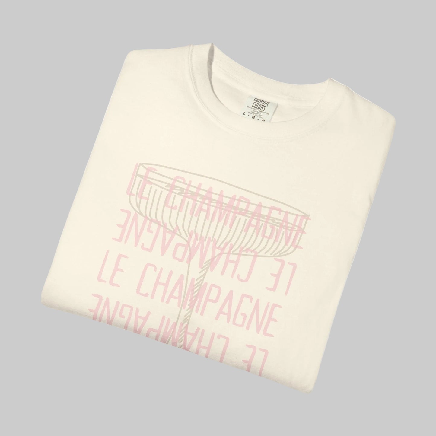 Folded cream-colored sweatshirt with pink text on a white background