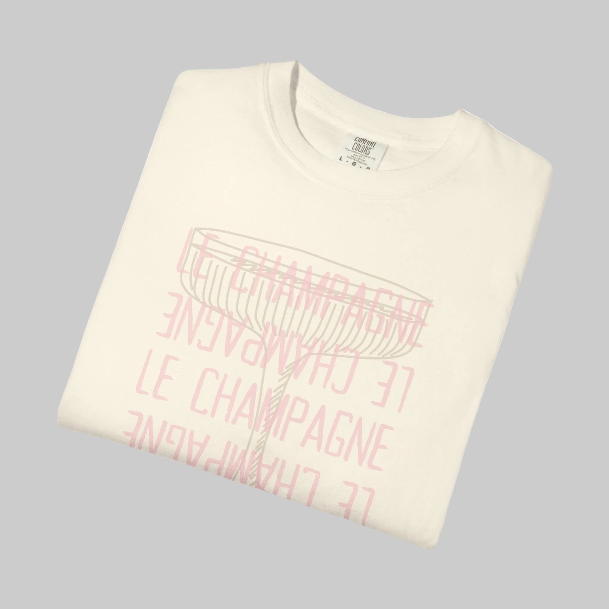 Folded cream-colored sweatshirt with pink text on a white background