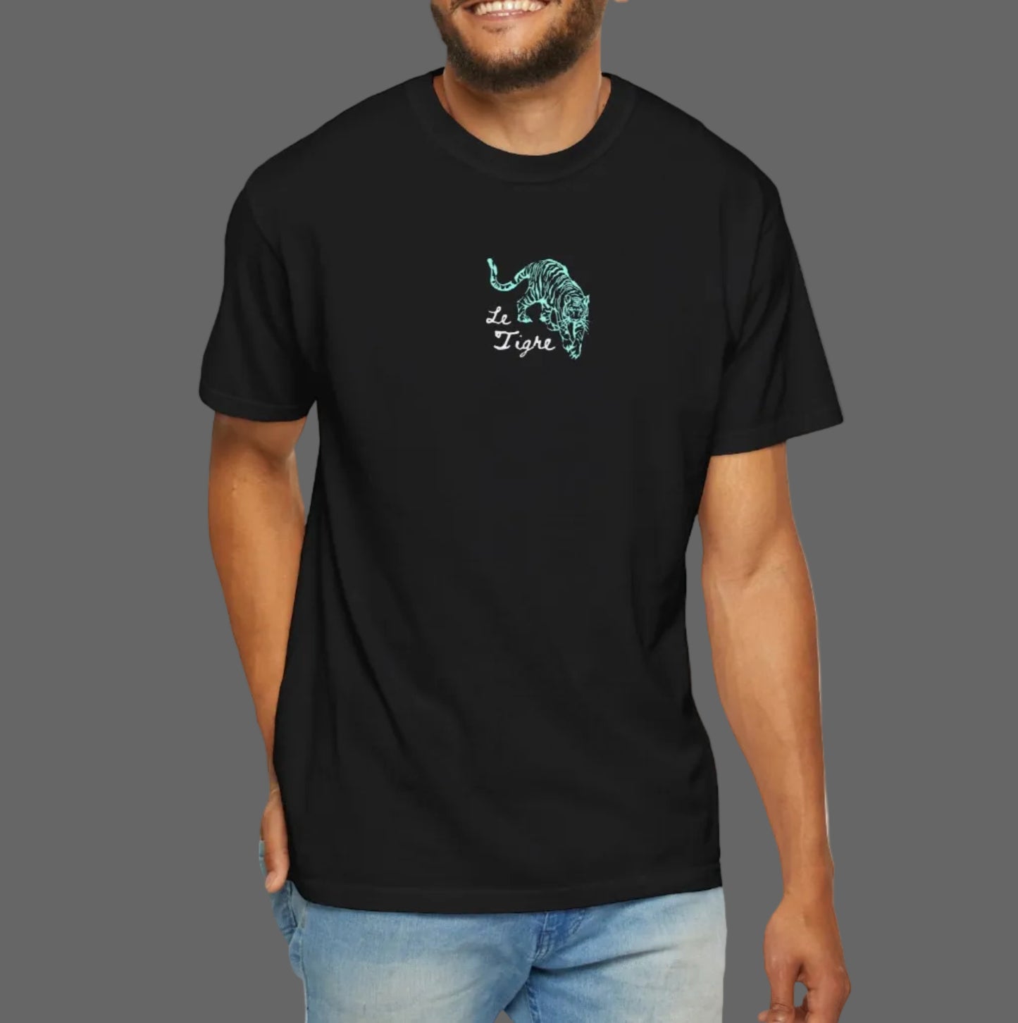 Man wearing a black t-shirt with a green graphic design on a white background