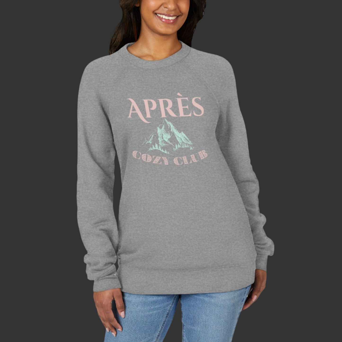 Woman wearing a gray sweatshirt with 'APRèS' and mountain graphic on a white background