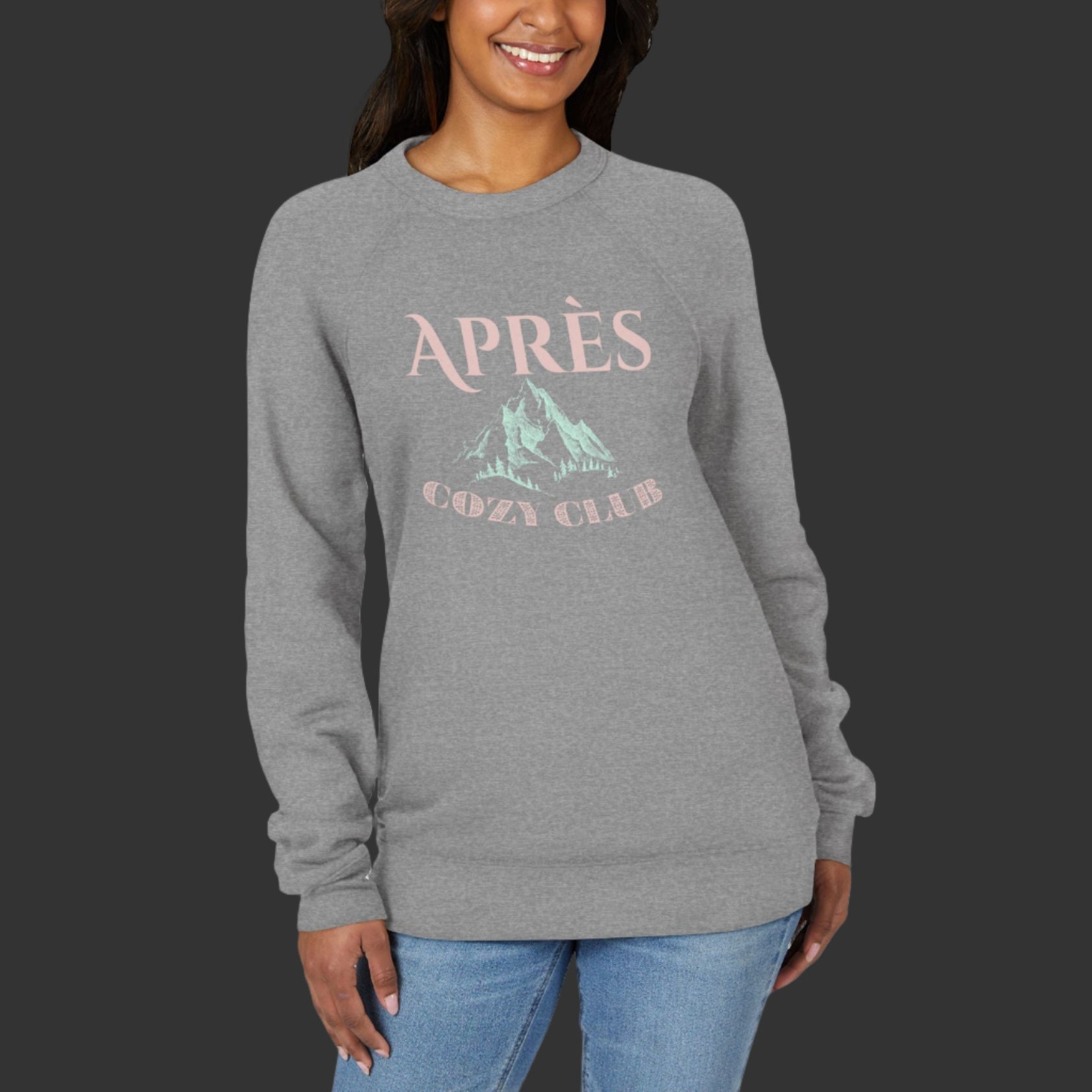Woman wearing a gray sweatshirt with 'APRèS' and mountain graphic on a white background