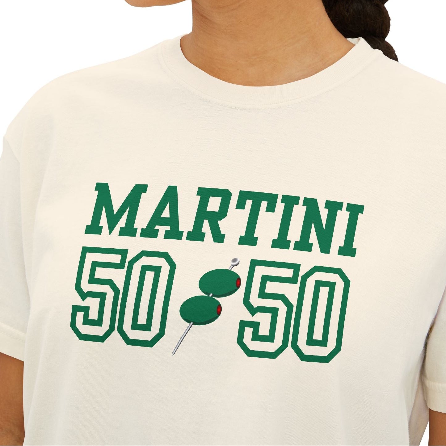 Person wearing a white t-shirt with 'Martini 50-50' text and olive graphics.