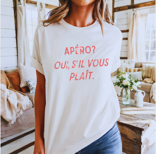 Person wearing a white t-shirt with red text in a cozy indoor setting